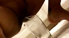 Young babe pissing on a glass