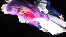 Japanese chick in costume and purple hair chews on his wanker